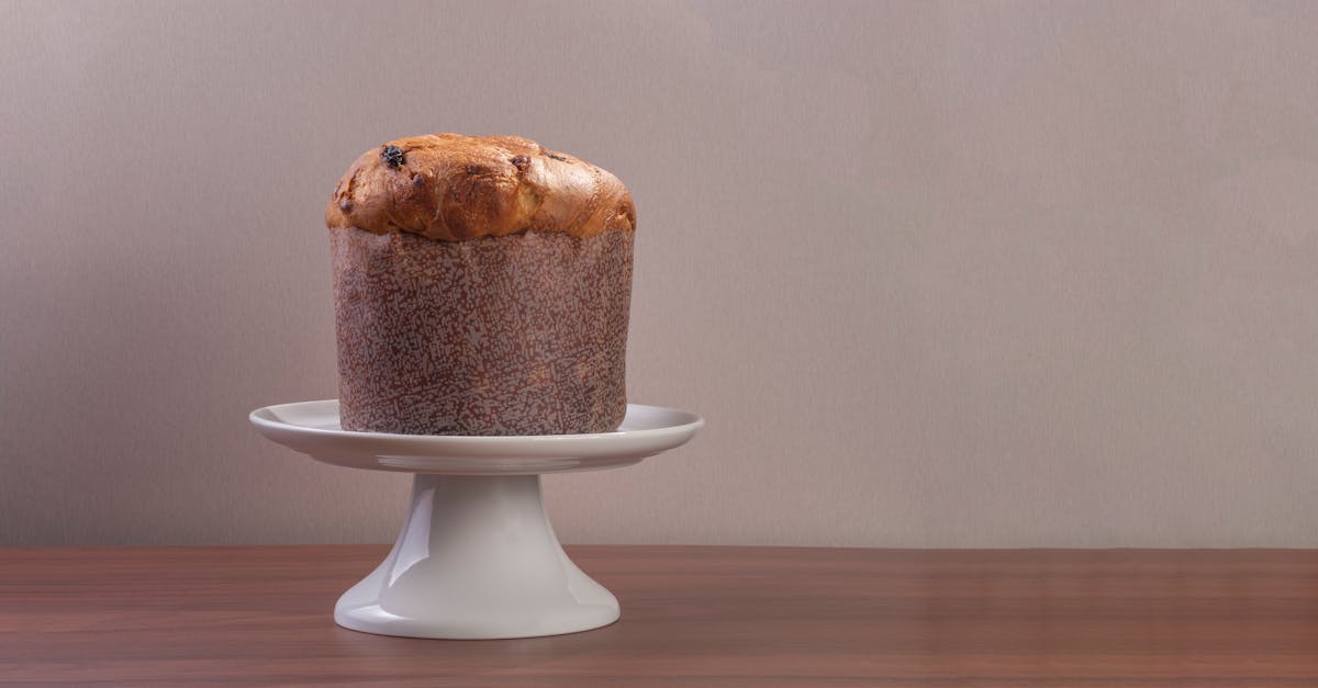 high quality image of a traditional italian panettone on a white cake stand