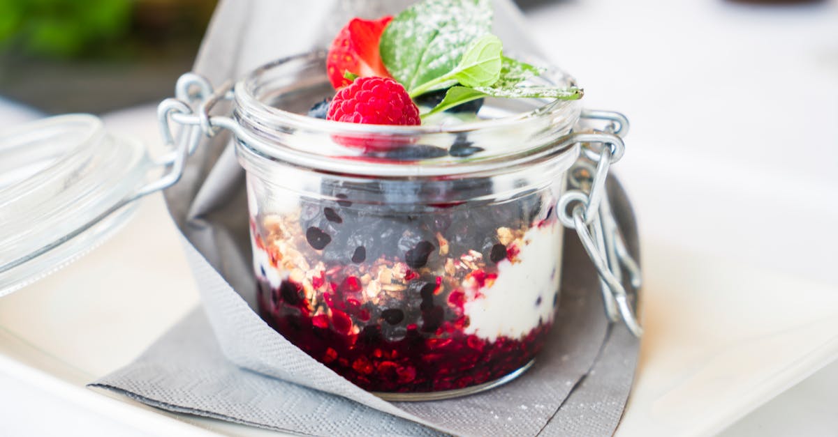homemade berry dessert with cream and mint in a glass jar perfect for breakfast 1