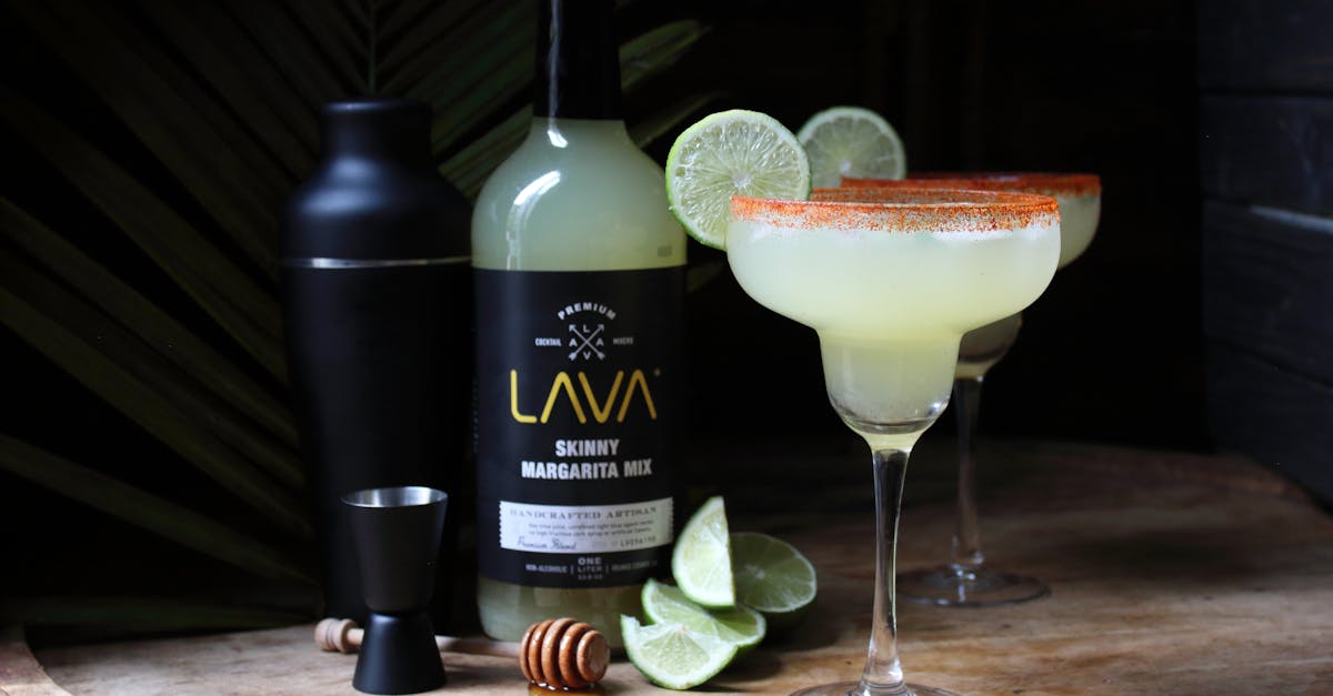 lime margaritas with salt rim on wood featuring lava mixer bottle perfect for cocktail enthusiasts
