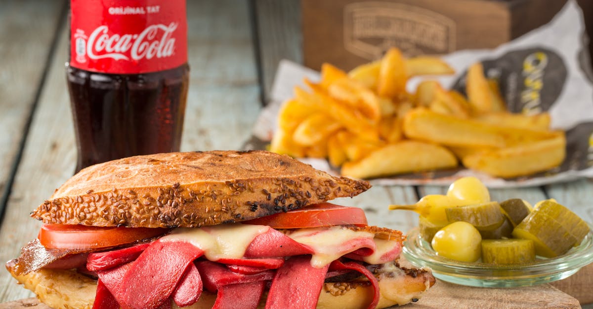 mouth watering sandwich with pickles and fries served with coca cola in sar yer turkey