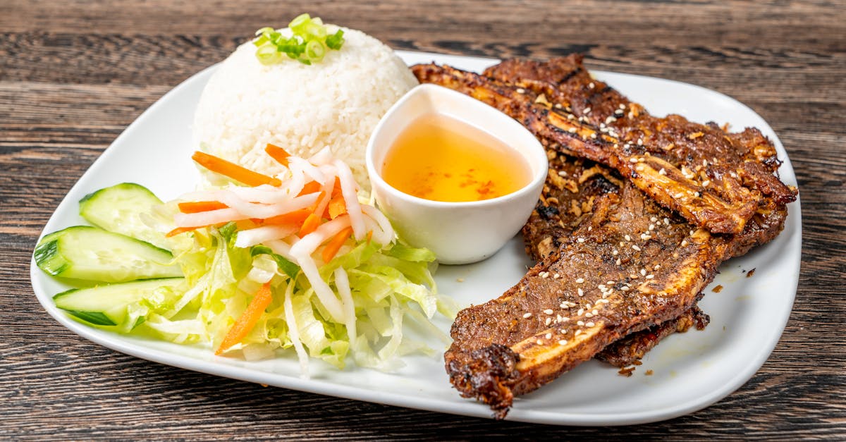 Home mouthwatering grilled beef ribs served with rice fresh veggies and dipping sauce 4