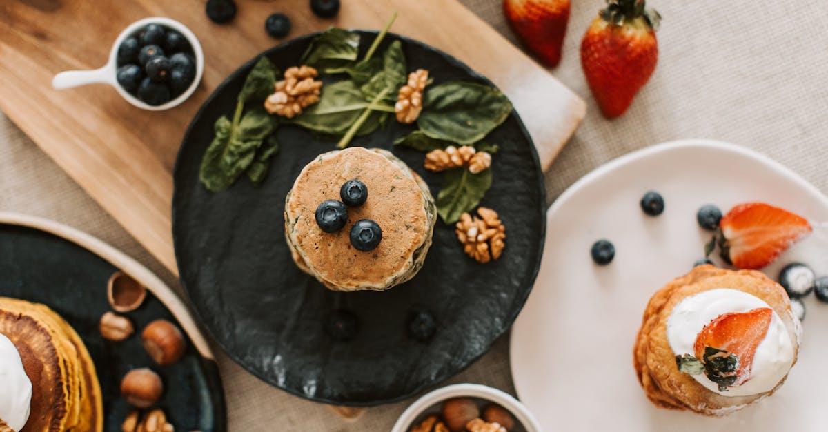 overhead shot of pancakes with blueberries strawberries and walnuts for breakfast