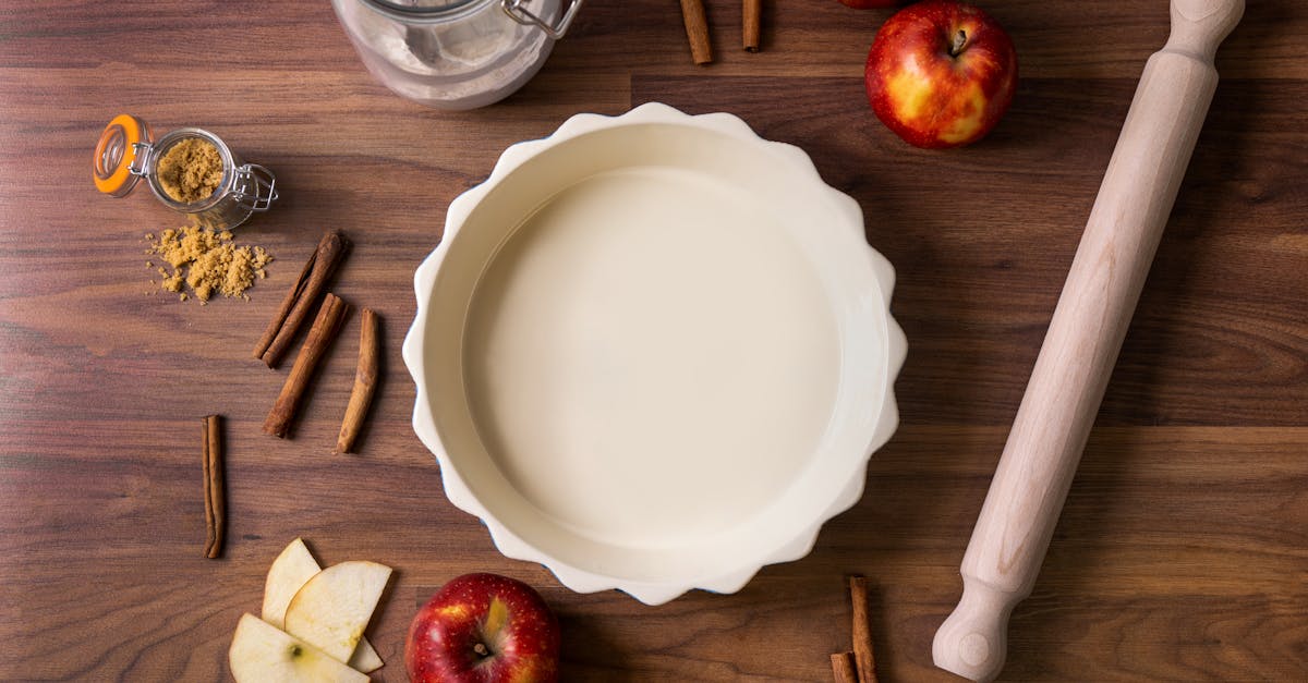overhead view of ingredients for apple pie including apples cinnamon sticks and rolling pin 11