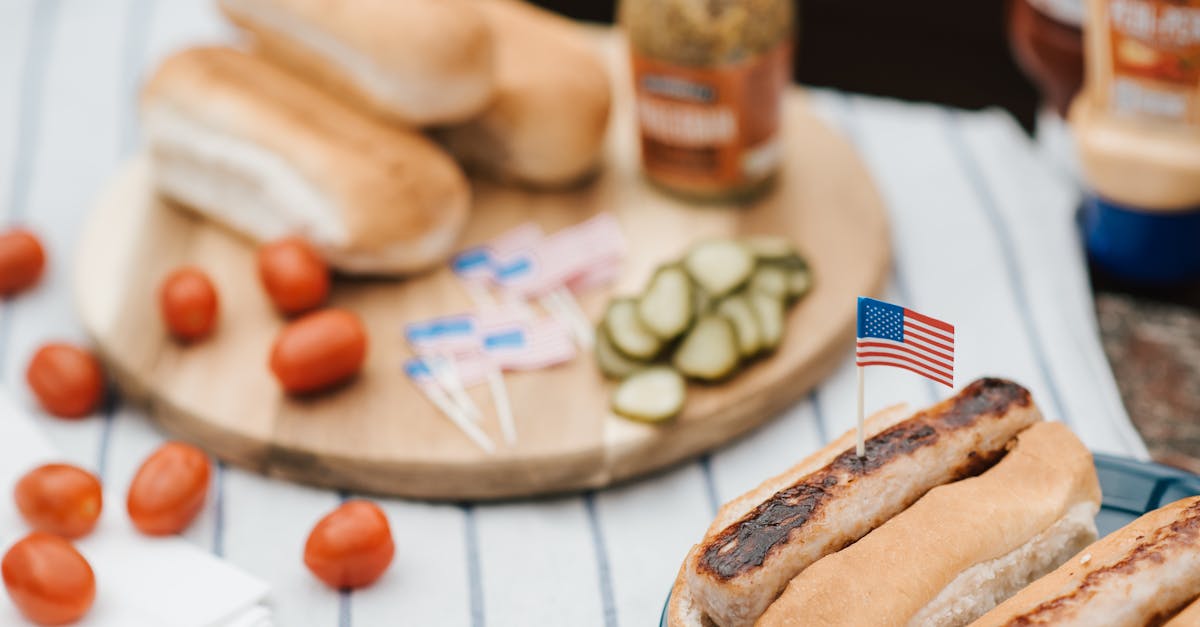 patriotic cookout featuring hot dogs with american flags pickles and mustard perfect for summer c