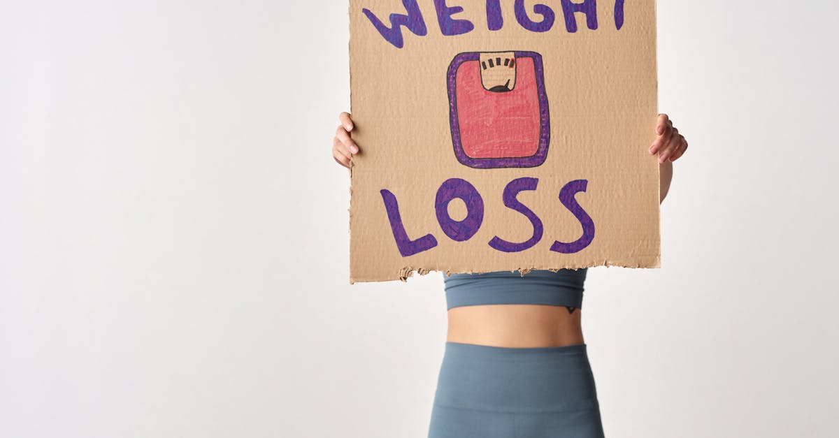 person holding weight loss sign for fitness motivation and health goals