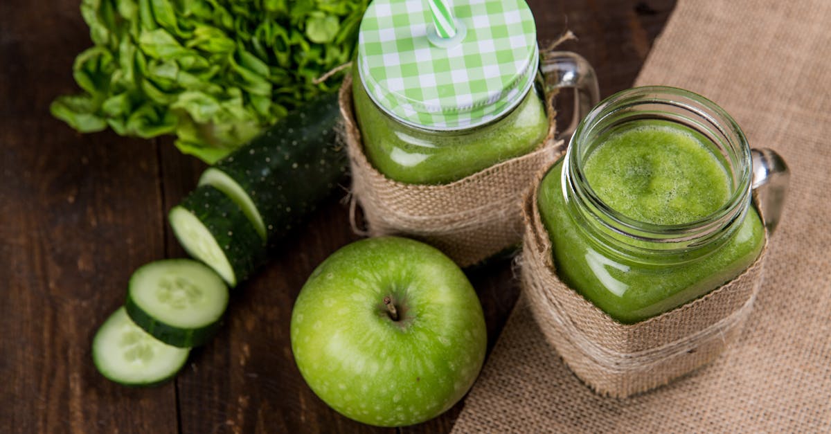 refreshing green smoothie made with apple cucumber and lettuce served in mason jars on wooden back 85