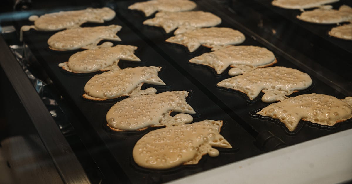 rows of traditional japanese taiyaki pancakes cooking on a grill showcasing the intricate patterns