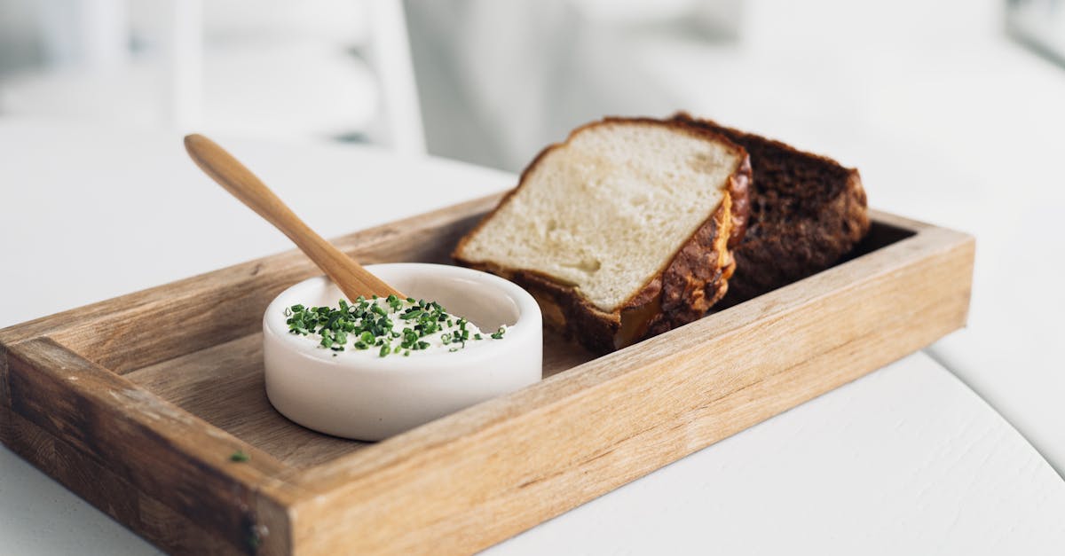 rustic bread served with creamy chive dip in a ceramic bowl on a wooden tray perfect for an appetiz 5
