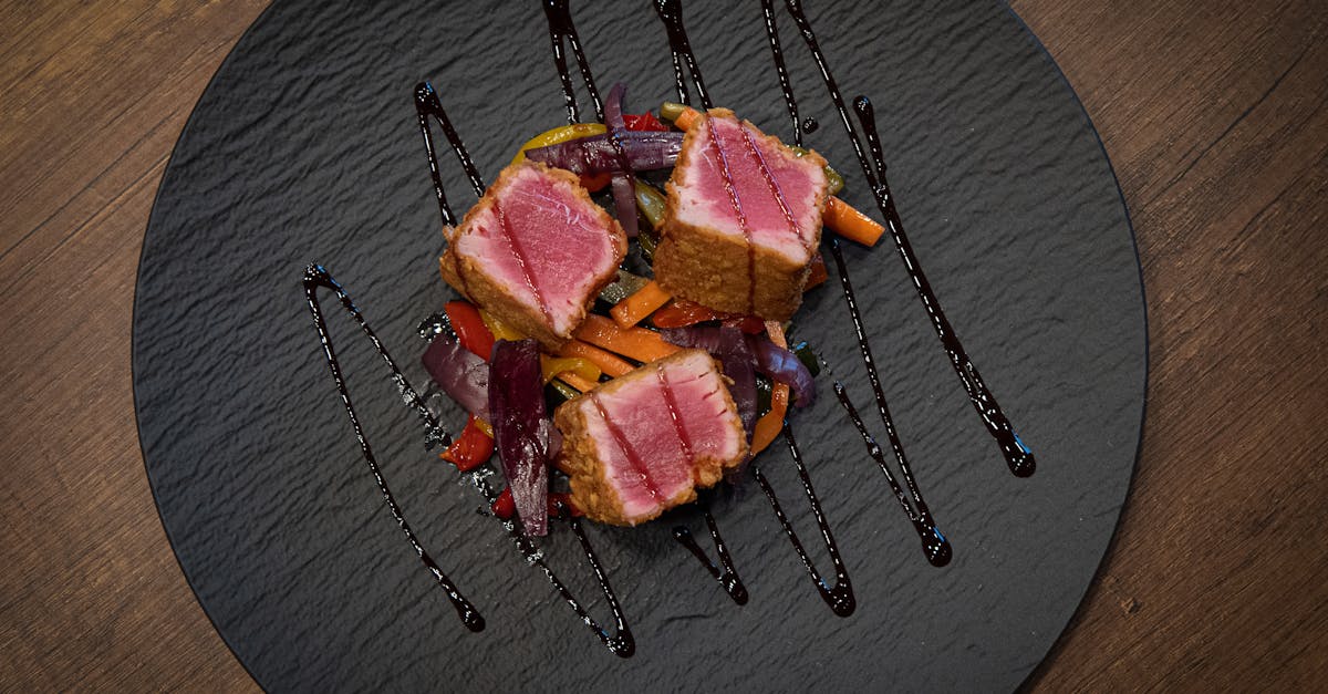 savor gourmet ahi tuna steak with colorful glazed vegetables on an elegant black plate 1