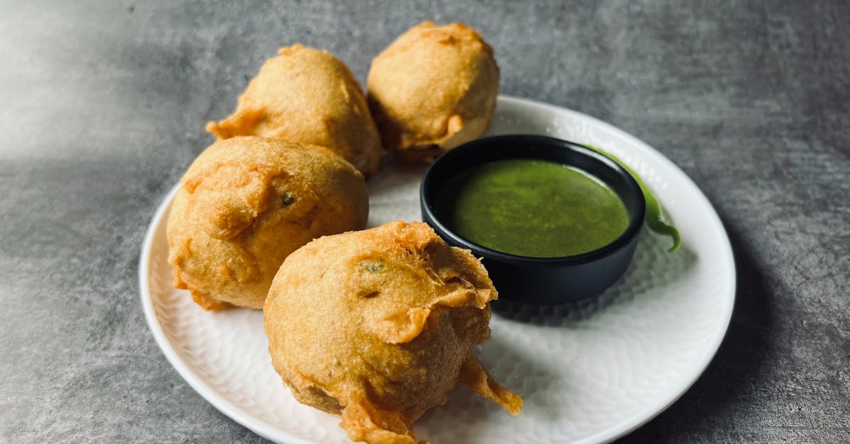 savor the taste of crispy indian batata vada served with flavorful green chutney on a plate 1