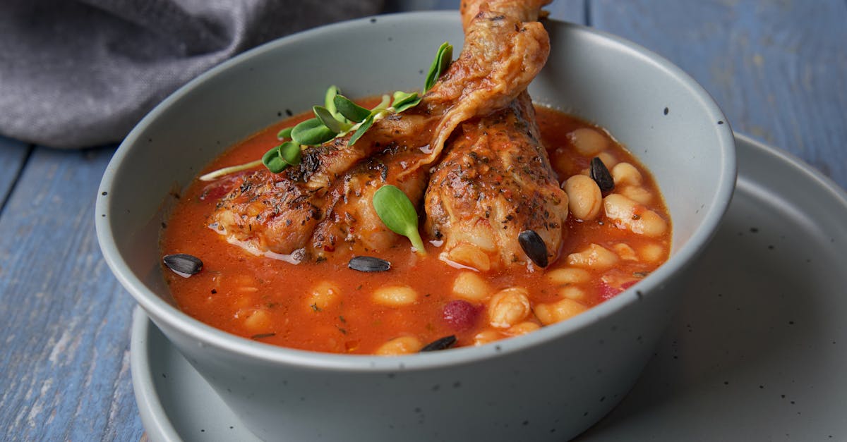 savor the taste of hearty chicken and bean stew served in a blue ceramic bowl