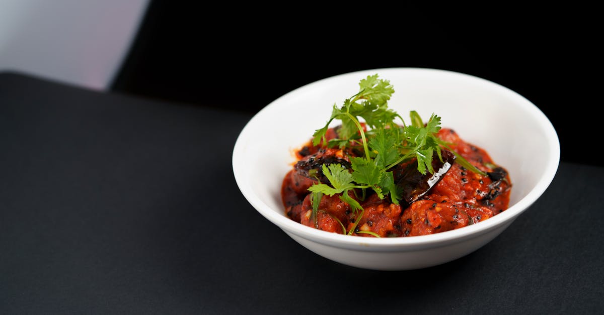 savor the vibrant flavors of hyderabadi eggplant curry garnished with fresh coriander
