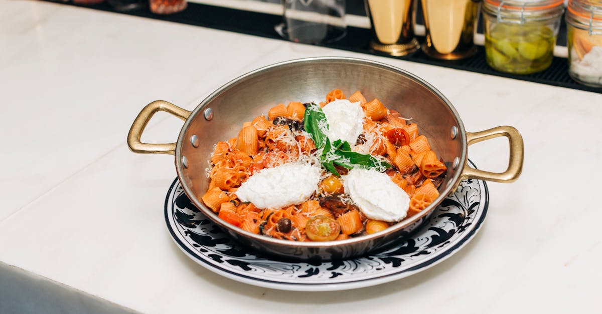 savor this delectable rigatoni pasta with fresh ricotta and basil garnish served in a rustic italia