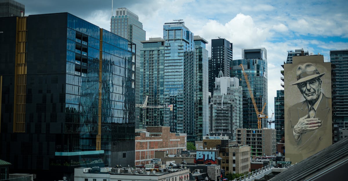 skyline view of downtown montreal featuring a notable mural of an iconic figure with modern skyscra