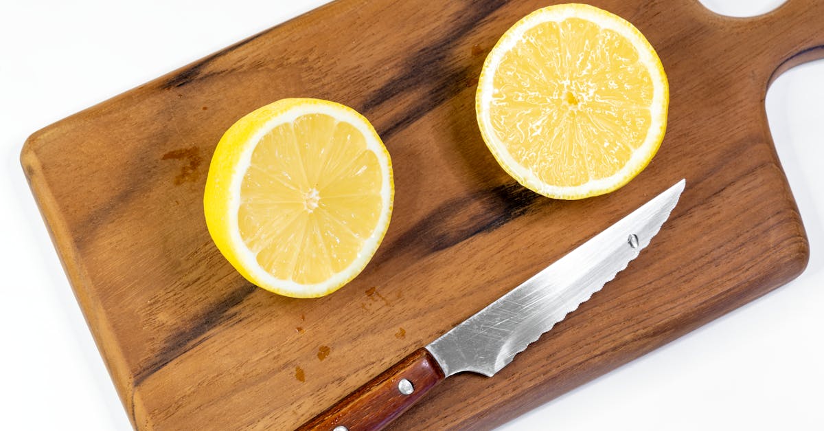 sliced lemon halves on a wooden cutting board perfect for food photography and culinary themes