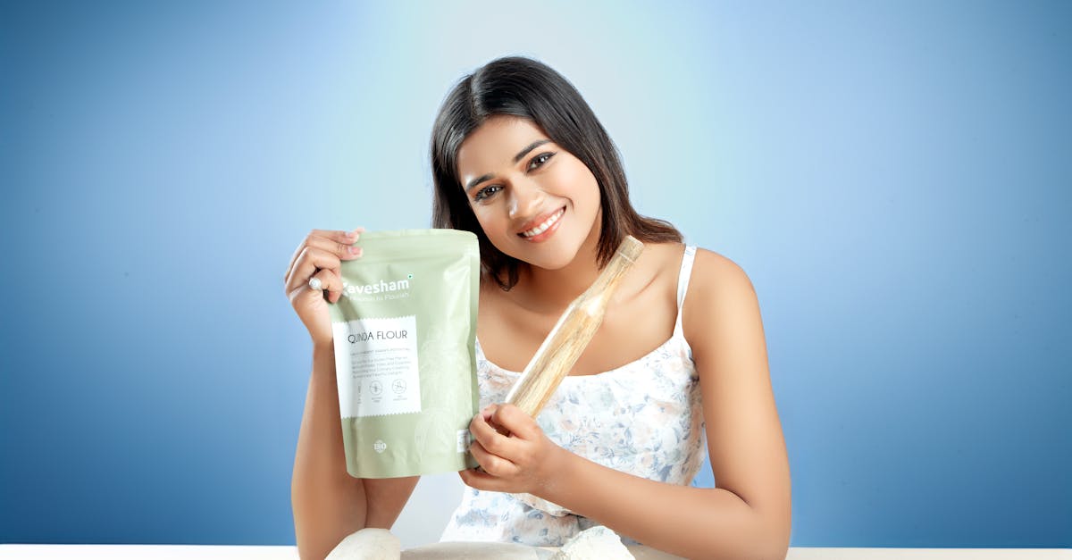 smiling woman holding goya flour with rolling pin ready for baking indoors