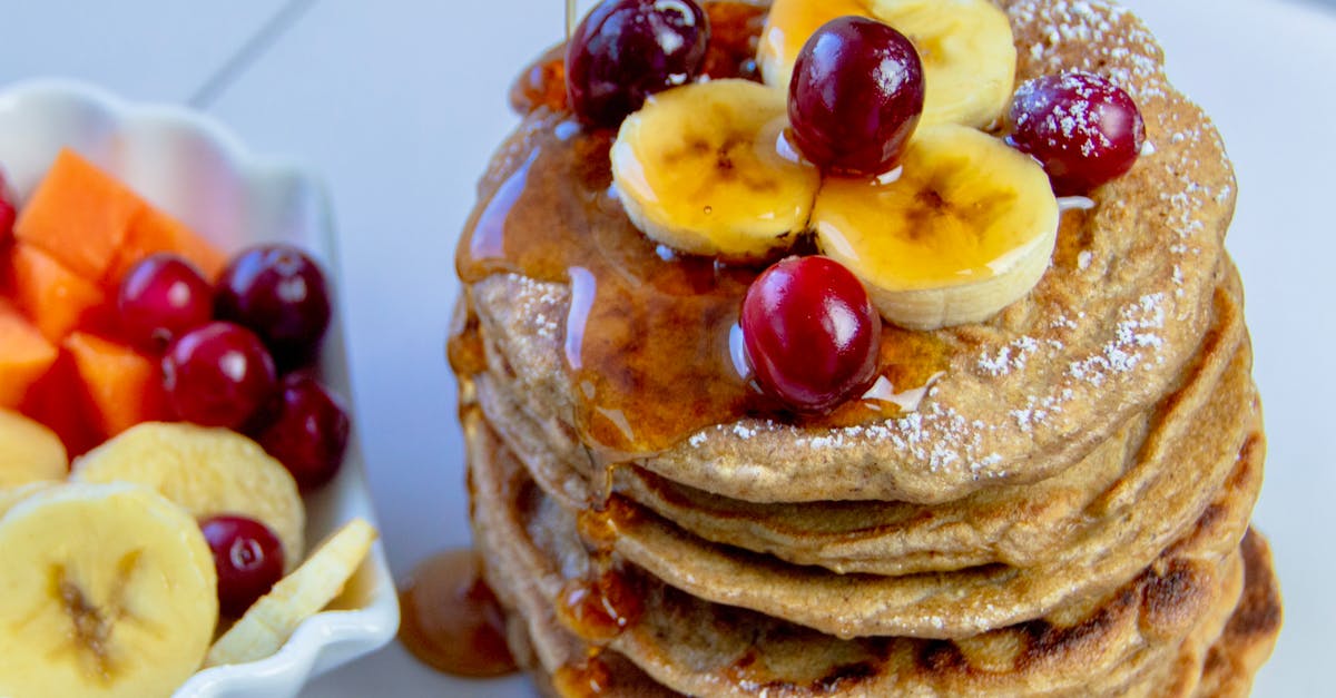 stack of pancakes topped with bananas and cherries drizzled with syrup perfect for breakfast 2