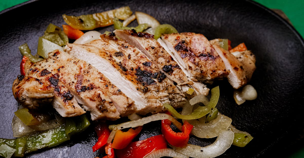 succulent grilled chicken with vibrant peppers on a sizzling plate perfect for a tasty meal