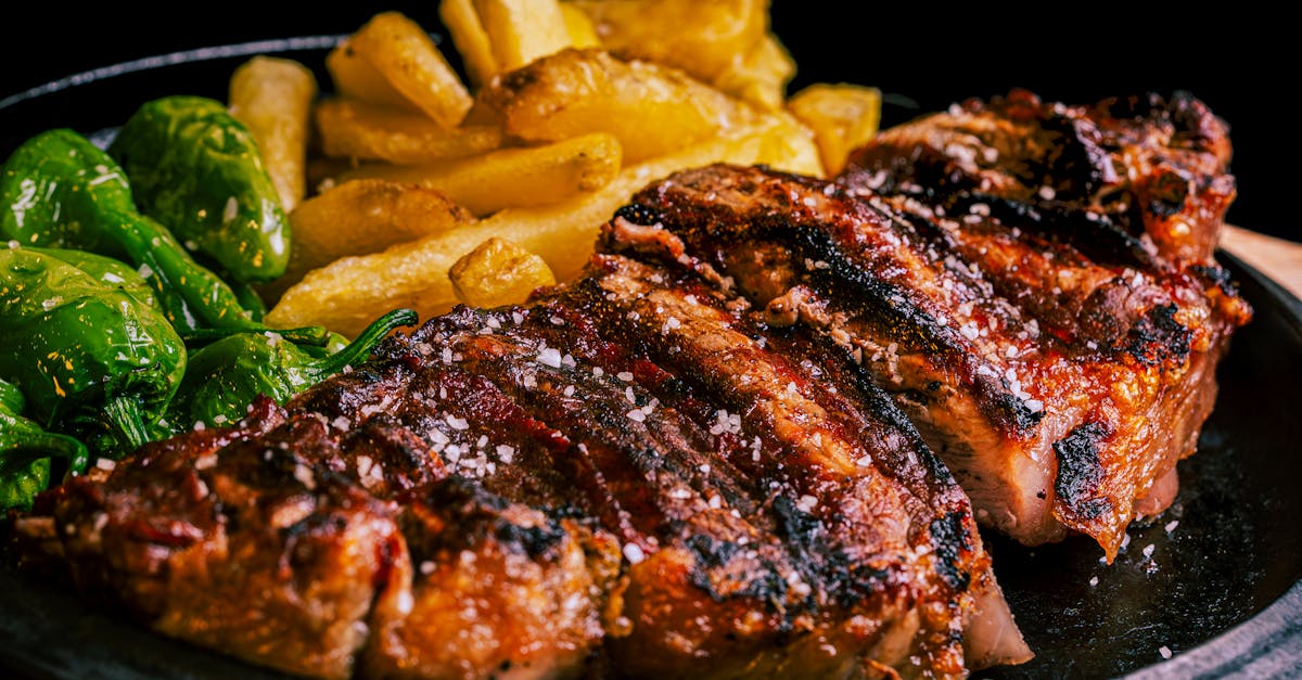 succulent grilled steak served with crispy fries and roasted green peppers 1