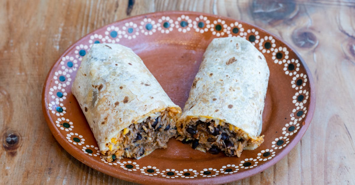 tasty burrito with rice and beans on a decorative plate perfect for breakfast or lunch 2