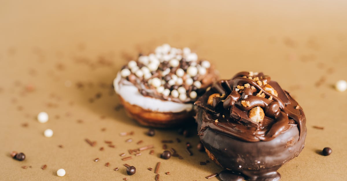 tasty chocolate covered donuts topped with sprinkles on a textured surface perfect for sweet cravin