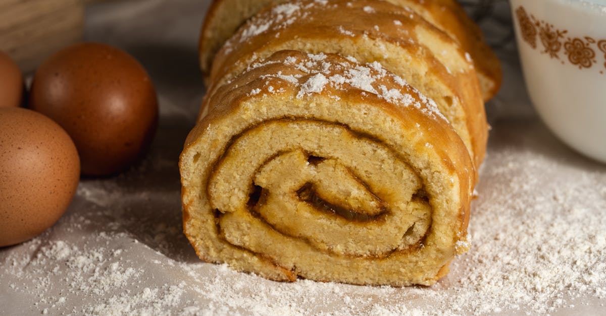 tasty homemade swiss roll cake surrounded by eggs and flour perfect for baking enthusiasts