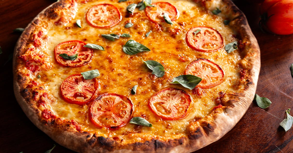 tasty margherita pizza topped with ripe tomatoes and fresh basil leaves on a wooden surface 1