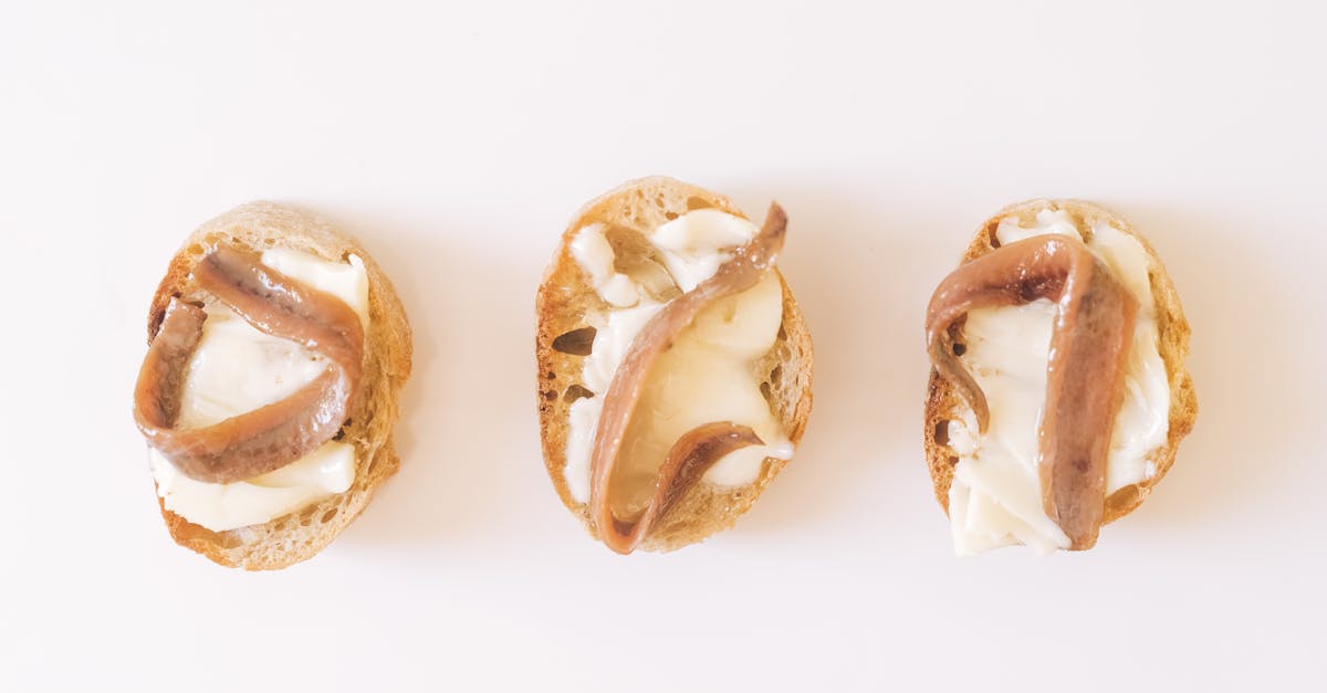 three slices of bread with butter and anchovies in a minimalist style perfect for simple snack or a 2