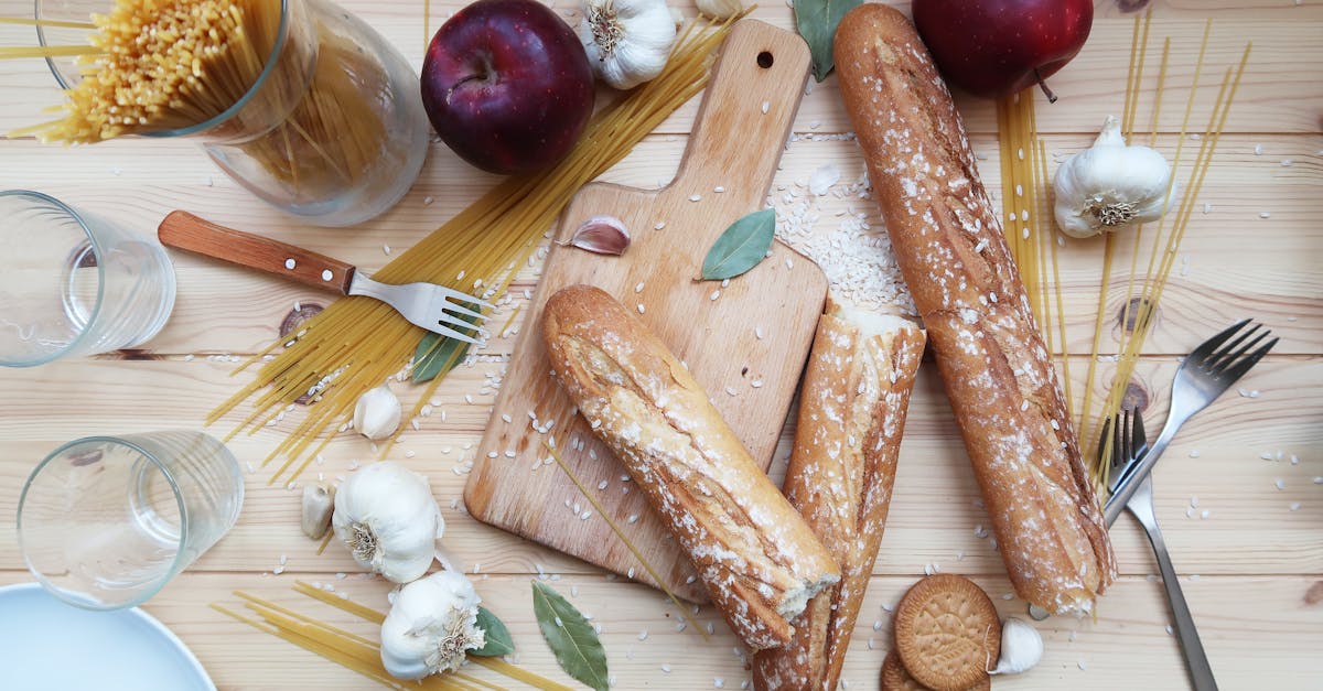top view of a rustic food arrangement with breads apples and spaghetti on a wooden table 3