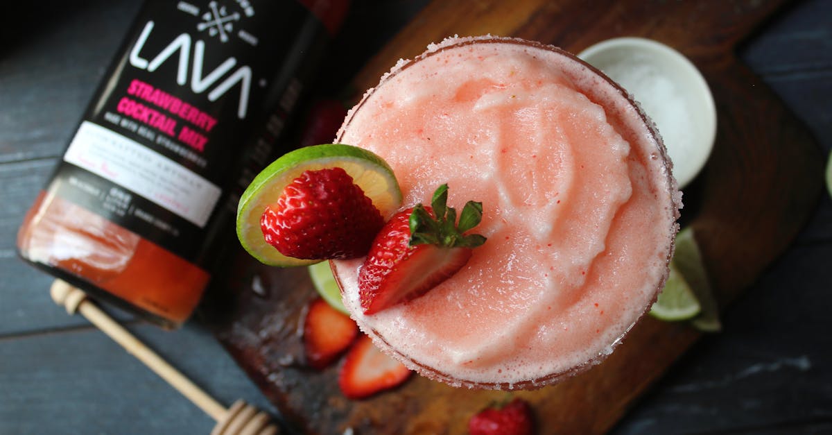top view of a strawberry daiquiri with lime on a wooden board perfect for summer vibes