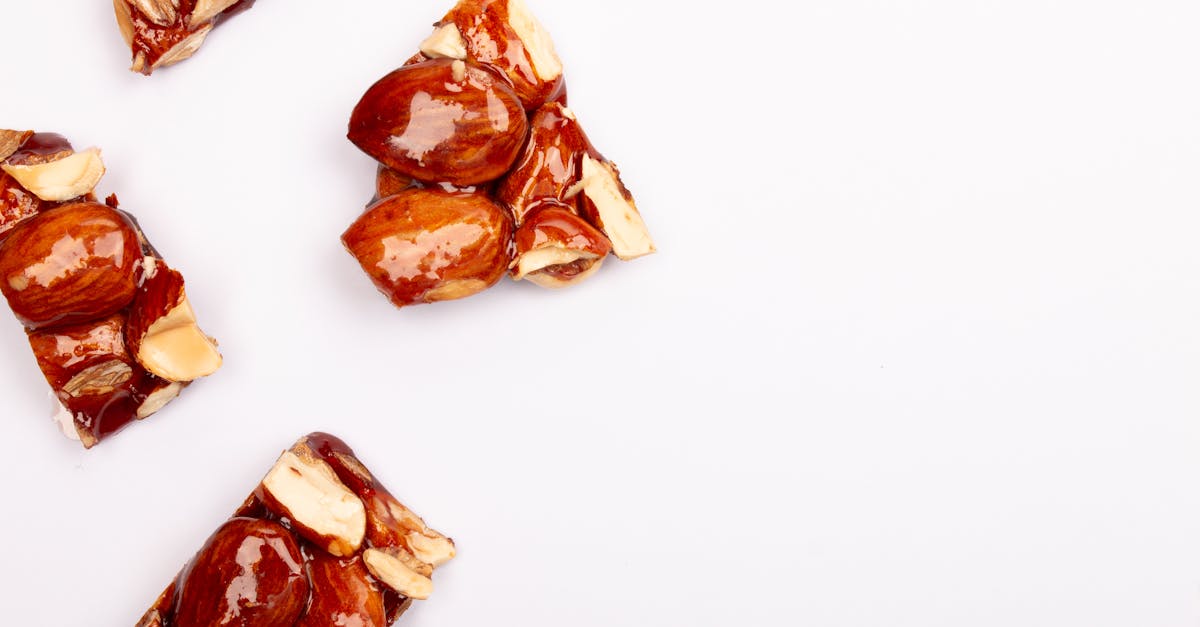 top view of almond and peanut brittle pieces on a white surface emphasizing texture and sweetness 1