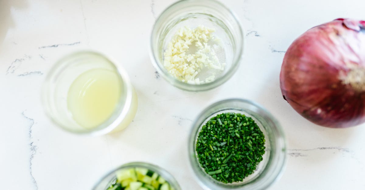 top view of chopped ingredients including onion herbs and garlic with lemon juice ready for cookin