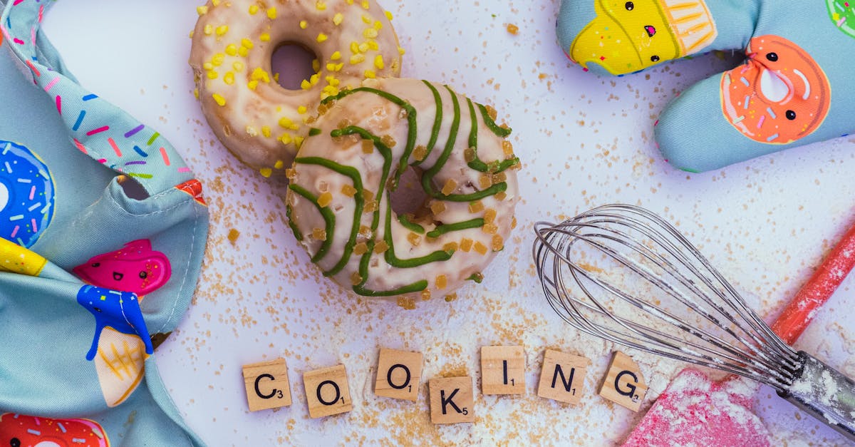 top view of donuts colorful baking items and cooking word on a table