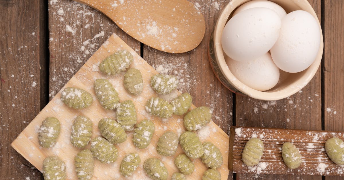 top view of fresh handmade green gnocchi and ingredients for cooking on a rustic wood table 3