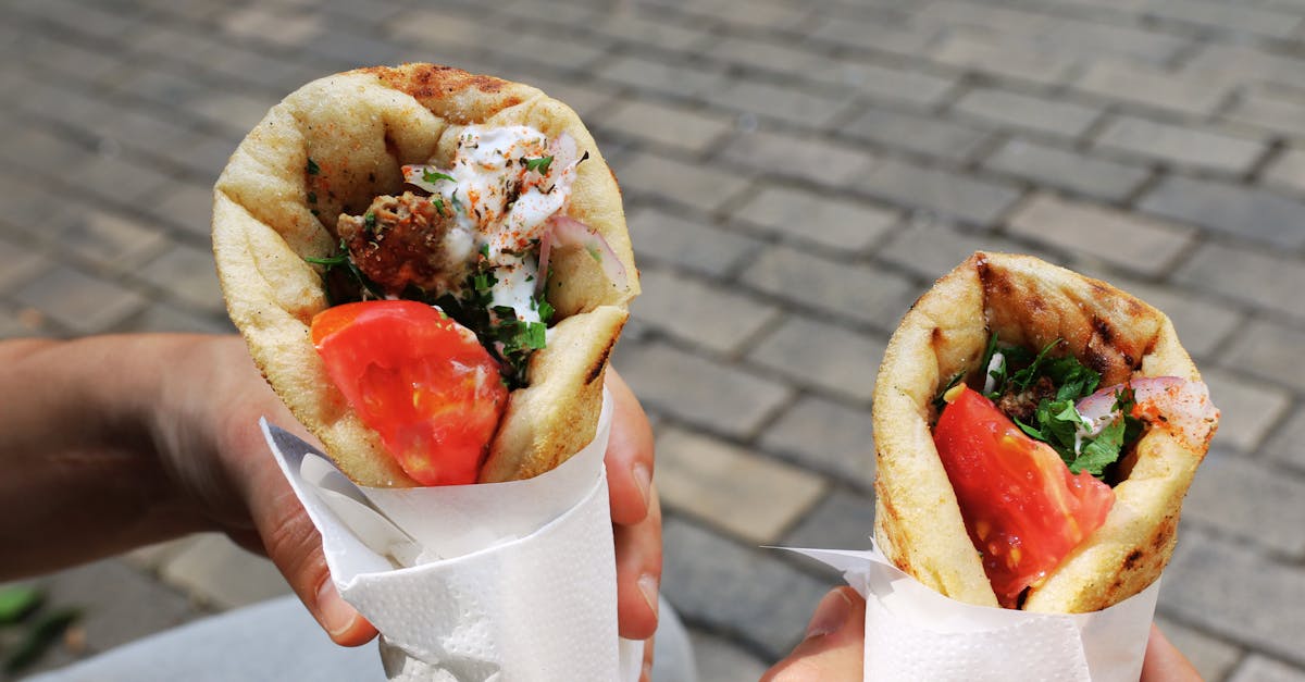 two fresh gyros with tomato and herbs perfect greek street food for a sunny day
