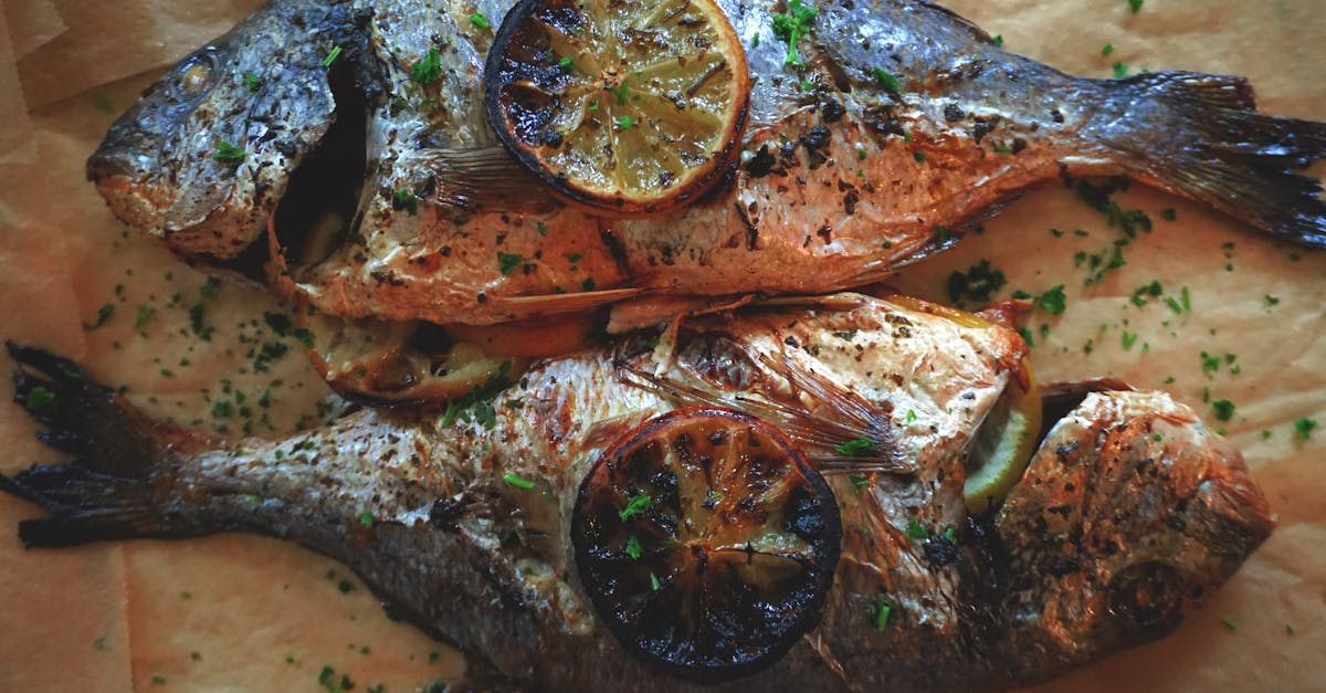 two grilled fish with lemon slices and herbs perfect for a savory meal 2