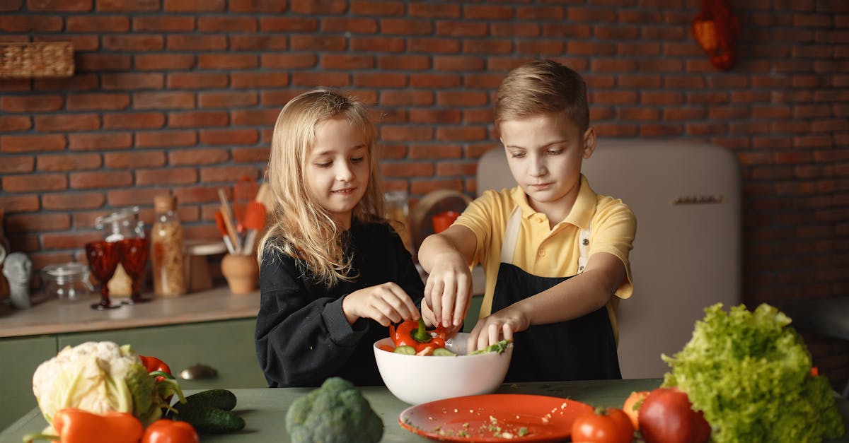 two kids in a kitchen making a healthy salad with fresh vegetables fun and engaging cooking