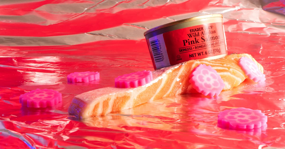 vibrant setup with canned pink salmon and decorative candies on reflective foil