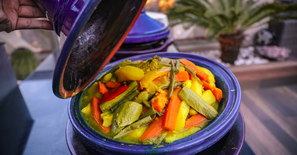vibrant vegetable tajine served in a traditional purple pot with a variety of fresh ingredients 1
