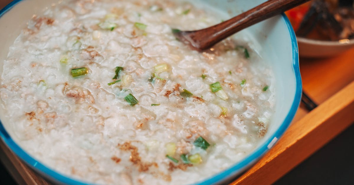 warm and comforting homemade rice porridge with scallions in a ceramic bowl perfect for breakfast