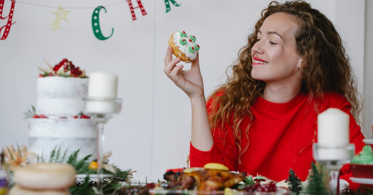 woman in red sweater enjoying a festive christmas dessert indoors surrounded by holiday decor and c