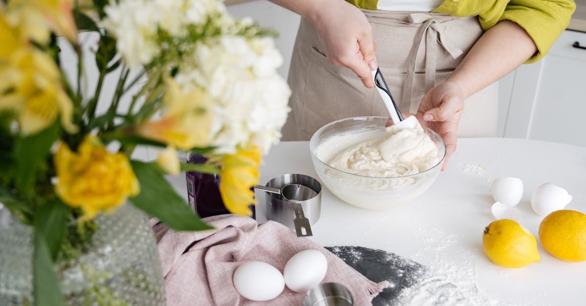 woman mixing cake batter in a modern kitchen with fresh lemons and flour surrounding 1
